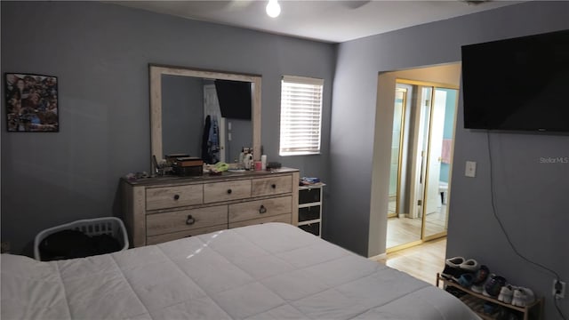 bedroom with ceiling fan, a closet, and light hardwood / wood-style flooring