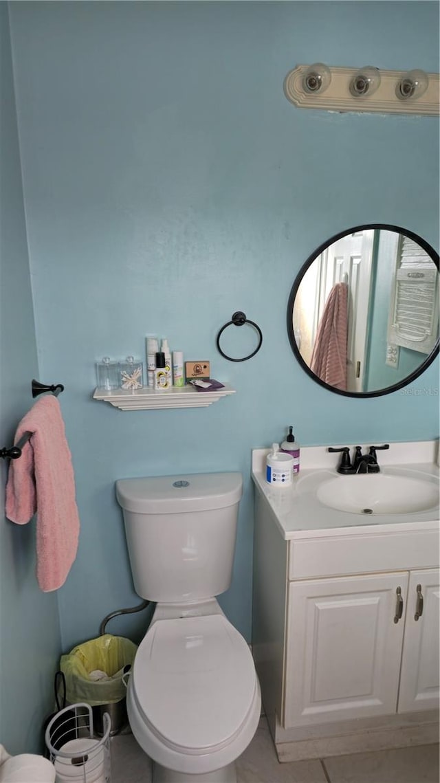 bathroom with tile patterned floors, vanity, and toilet