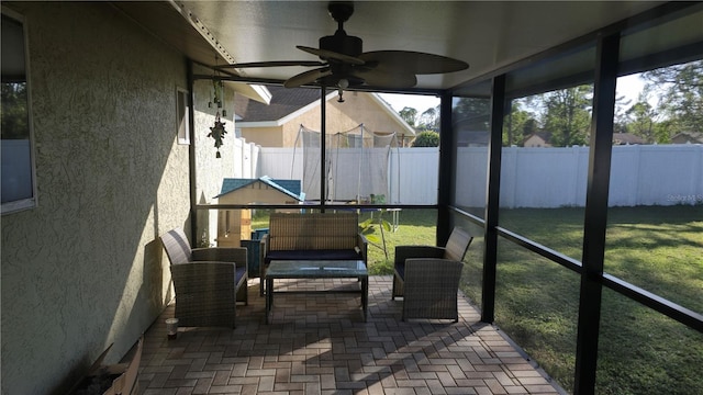 sunroom / solarium featuring ceiling fan and a healthy amount of sunlight