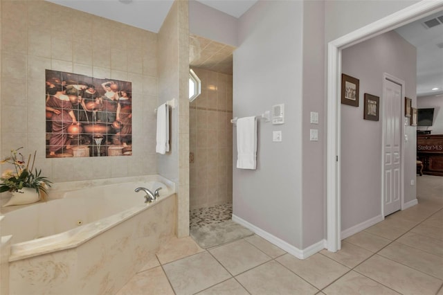 bathroom with tile patterned floors and independent shower and bath