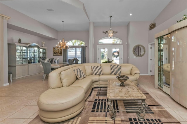 living room featuring a chandelier, french doors, lofted ceiling, and light tile patterned flooring