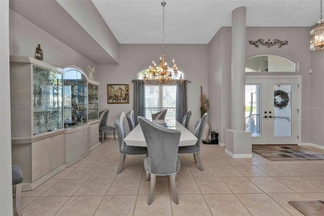 dining space with french doors, light tile patterned flooring, and a notable chandelier