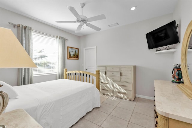 tiled bedroom featuring ceiling fan