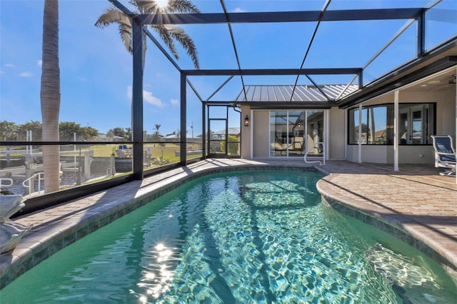 view of pool with a patio area and a lanai