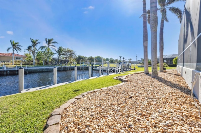 view of yard with a boat dock and a water view