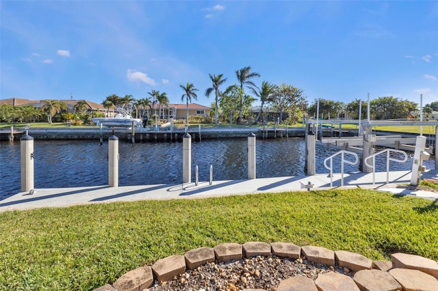 view of dock featuring a water view and a yard