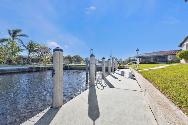 dock area with a yard and a water view