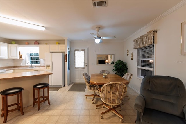 dining area with ornamental molding, ceiling fan, a healthy amount of sunlight, and sink