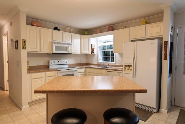 kitchen with white appliances, crown molding, sink, a center island, and white cabinetry