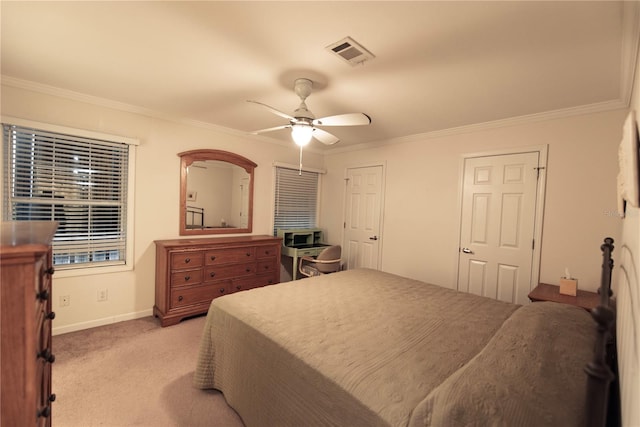 carpeted bedroom with ceiling fan and ornamental molding