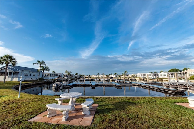 view of dock featuring a yard and a water view