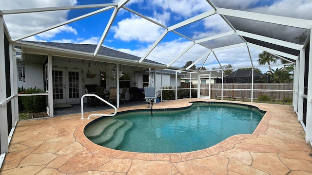 view of pool with a patio area, french doors, and glass enclosure