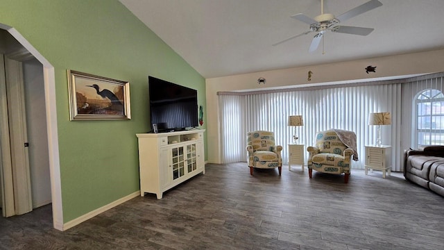 living room featuring vaulted ceiling, ceiling fan, and dark wood-type flooring