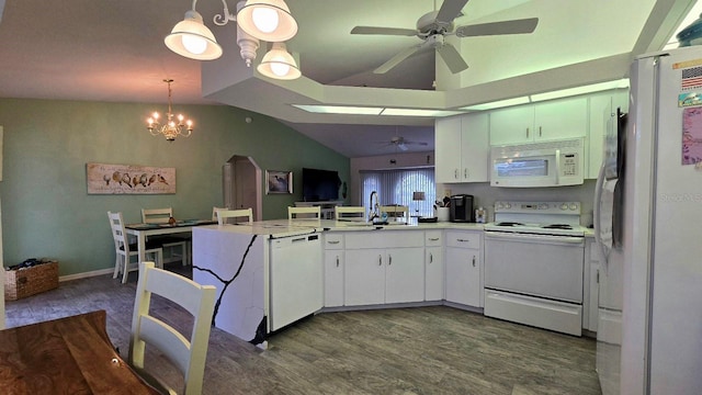 kitchen featuring kitchen peninsula, dark hardwood / wood-style flooring, white appliances, hanging light fixtures, and lofted ceiling