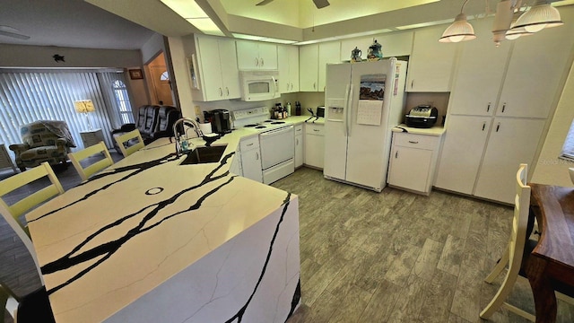 kitchen featuring sink, white cabinets, pendant lighting, and white appliances