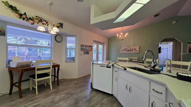 kitchen featuring white cabinetry, white dishwasher, hanging light fixtures, and vaulted ceiling