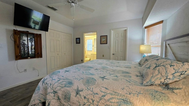 bedroom featuring ensuite bath, ceiling fan, a closet, and dark wood-type flooring