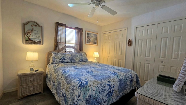 bedroom featuring multiple closets, ceiling fan, and dark hardwood / wood-style floors