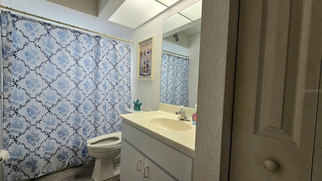 bathroom featuring hardwood / wood-style floors, vanity, and toilet