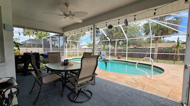 view of pool featuring ceiling fan, a patio, and glass enclosure