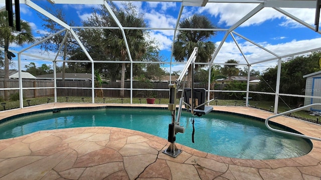 view of swimming pool with a lanai and a patio