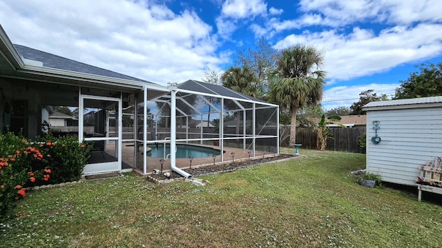 view of yard with a fenced in pool and glass enclosure