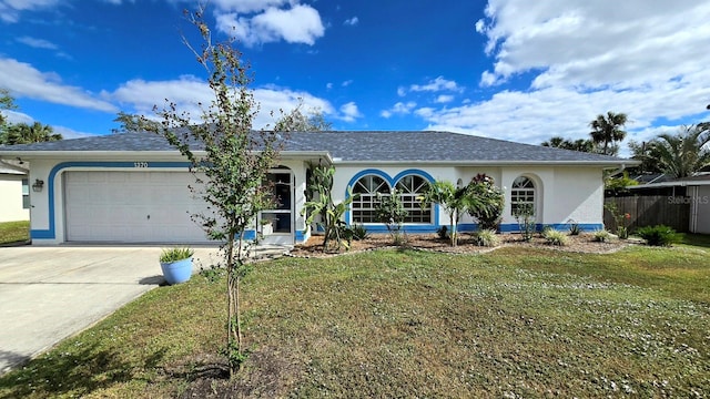 single story home with a front yard and a garage