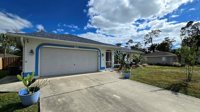 ranch-style home with a garage, a front lawn, and cooling unit