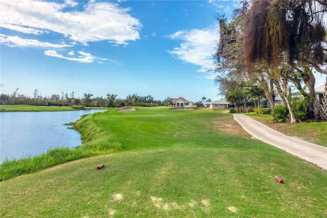 view of home's community featuring a lawn and a water view