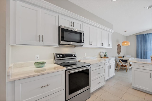 kitchen with white cabinetry, hanging light fixtures, stainless steel appliances, lofted ceiling, and light tile patterned flooring