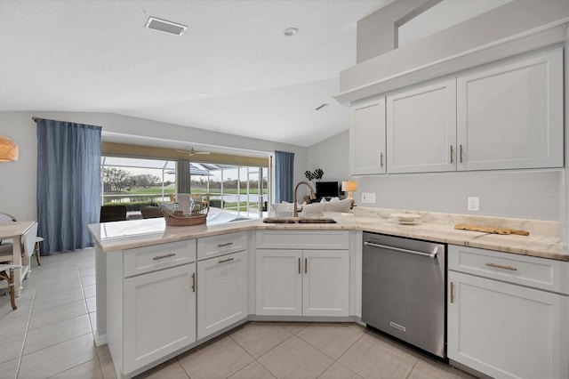 kitchen with vaulted ceiling, white cabinetry, stainless steel dishwasher, and sink