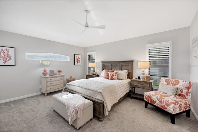 bedroom with ceiling fan and light carpet