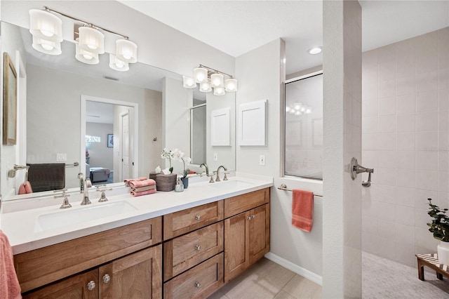 bathroom featuring a tile shower, tile patterned flooring, and vanity