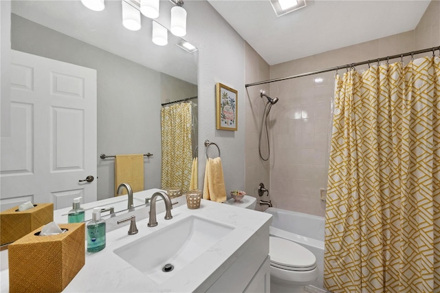 full bathroom featuring vanity, shower / bath combination with curtain, and toilet