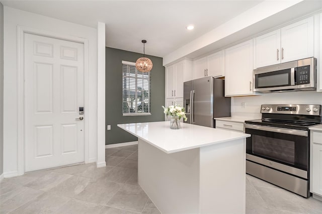 kitchen featuring white cabinetry, a center island, pendant lighting, and appliances with stainless steel finishes