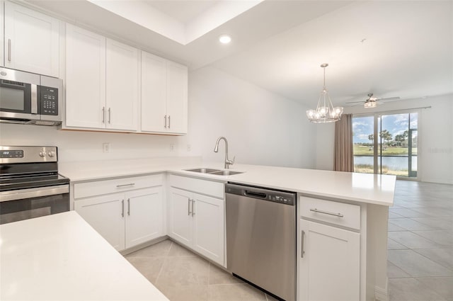 kitchen featuring sink, kitchen peninsula, white cabinets, ceiling fan with notable chandelier, and appliances with stainless steel finishes