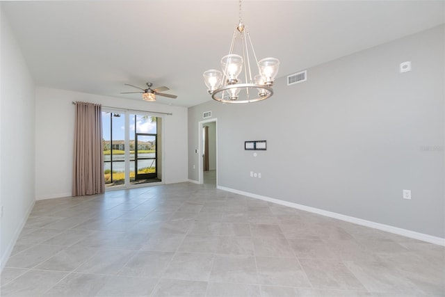 empty room featuring ceiling fan with notable chandelier and light tile patterned floors