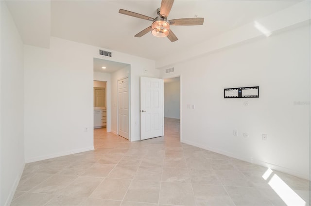 spare room featuring ceiling fan and light tile patterned floors