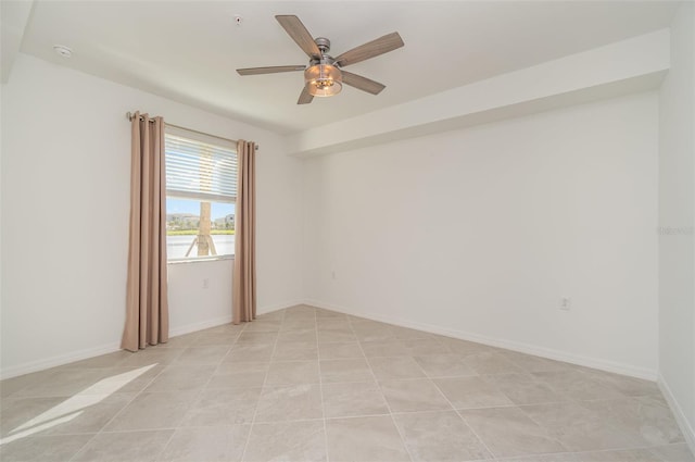 tiled spare room with ceiling fan