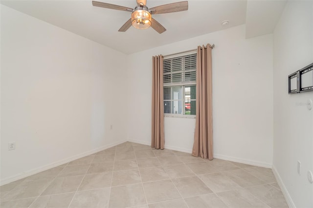 spare room featuring ceiling fan and light tile patterned flooring