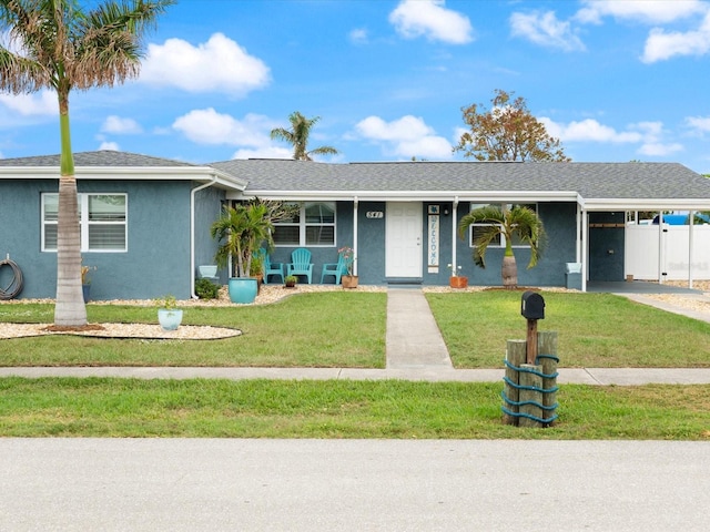 ranch-style home featuring a front yard and a carport