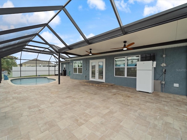 view of swimming pool featuring a lanai, french doors, and a patio