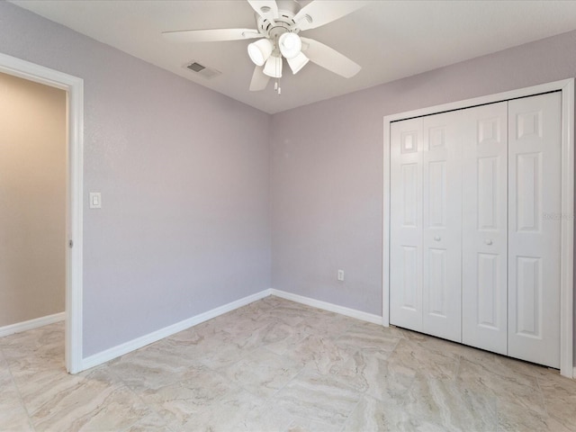 unfurnished bedroom with a closet and ceiling fan