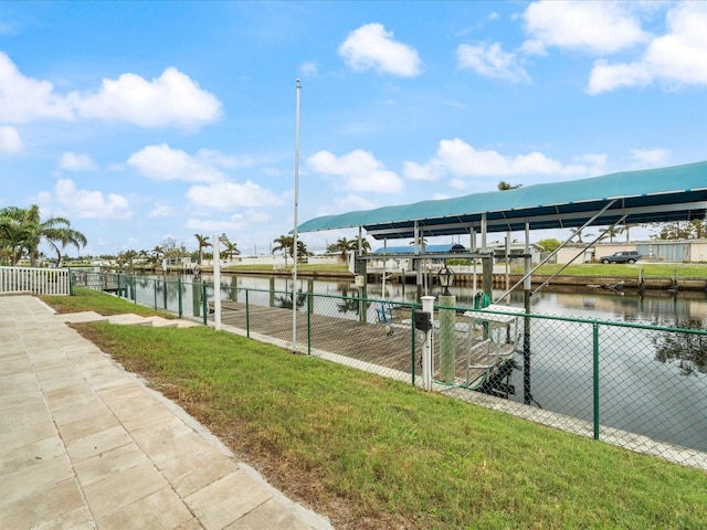 dock area with a yard and a water view