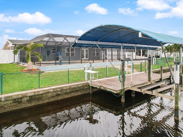 view of dock featuring a lanai, a yard, and a water view