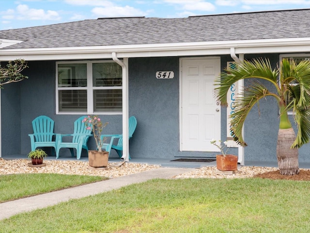 view of exterior entry featuring a yard