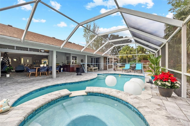 view of swimming pool featuring an in ground hot tub, a lanai, and a patio area