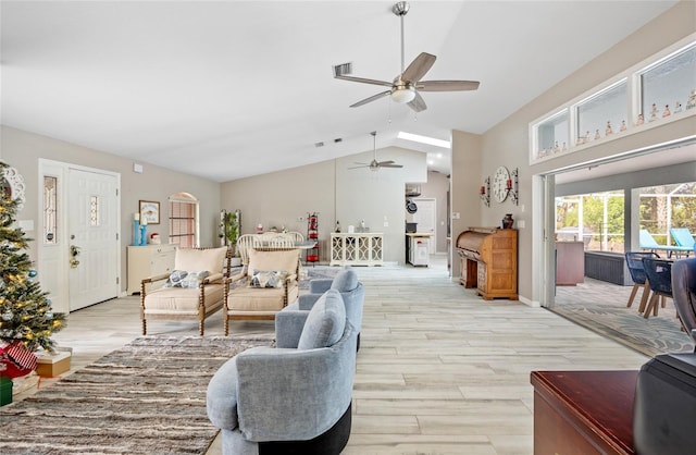 living room with ceiling fan, light wood-type flooring, and lofted ceiling