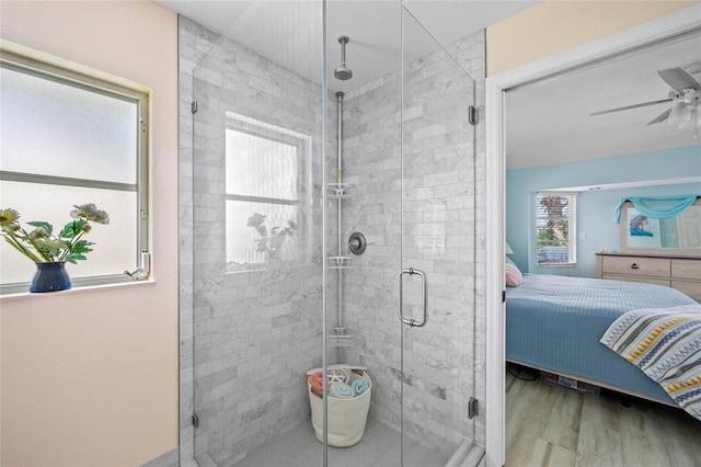 bathroom featuring walk in shower, wood-type flooring, and plenty of natural light