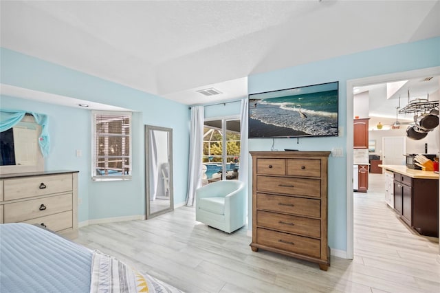 bedroom featuring access to exterior and light hardwood / wood-style flooring